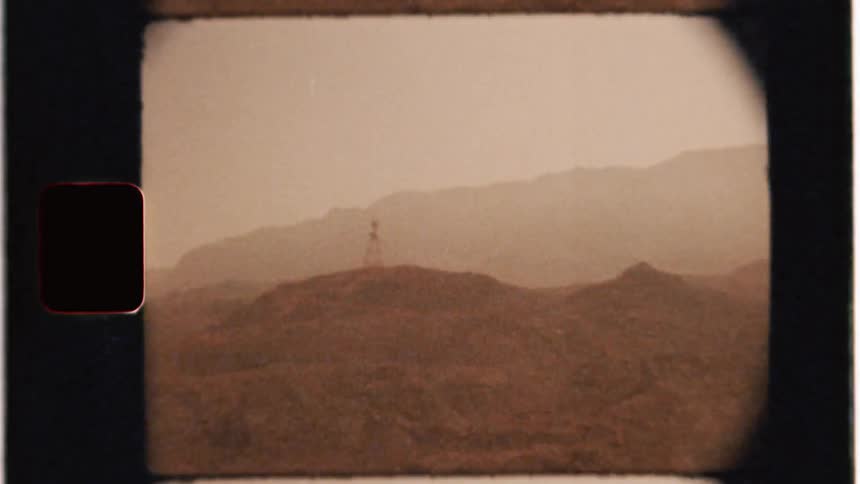A radio tower stands tall from atop the hill