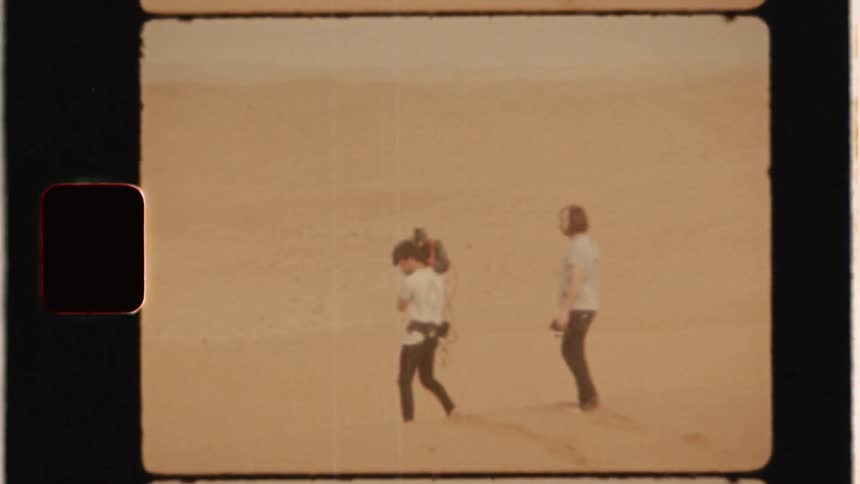 A film crew works in the desert