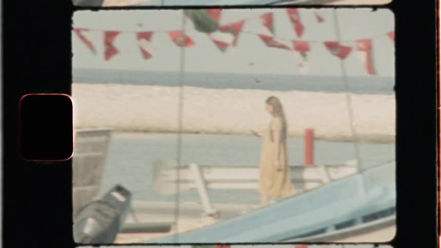 A woman walks on the beach pier