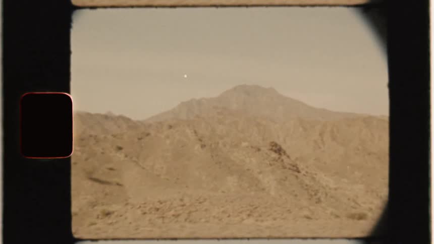 Hills sit under a cloudy sky