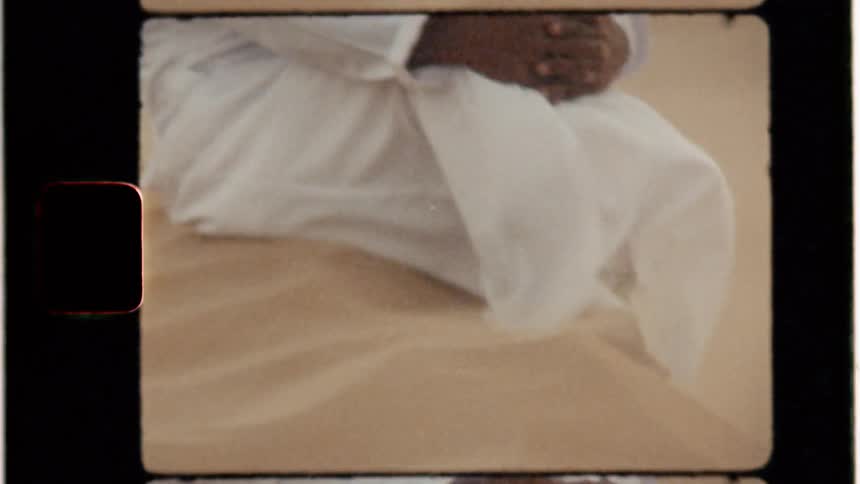 A man sits in the windy desert