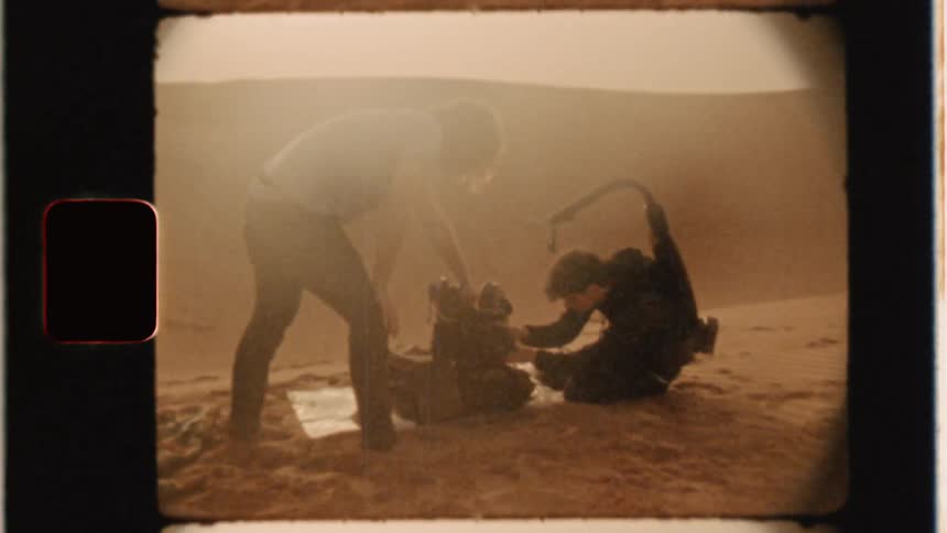 Men in desert adjusting camera equipment