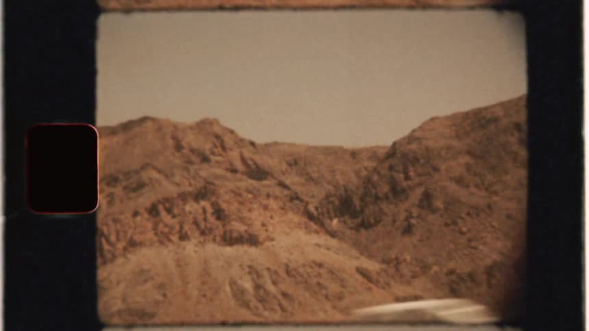 A car travels in a rocky desert