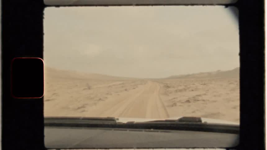 A car drives on a dirt path