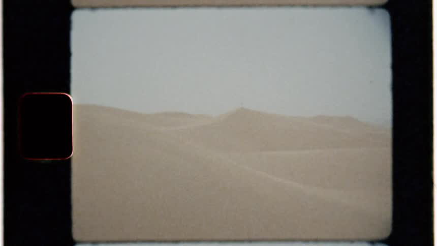 Person stands on a sand pile in a desert