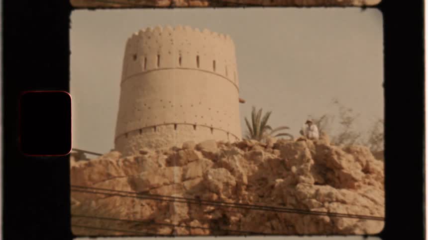 Person next to small castle tower