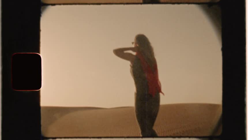 A woman walks in the desert