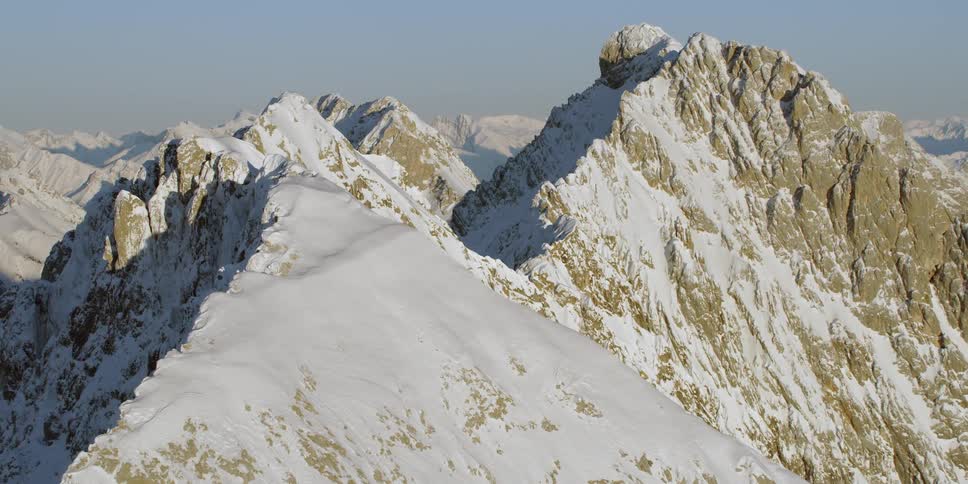 Snow covers rocky mountain peaks