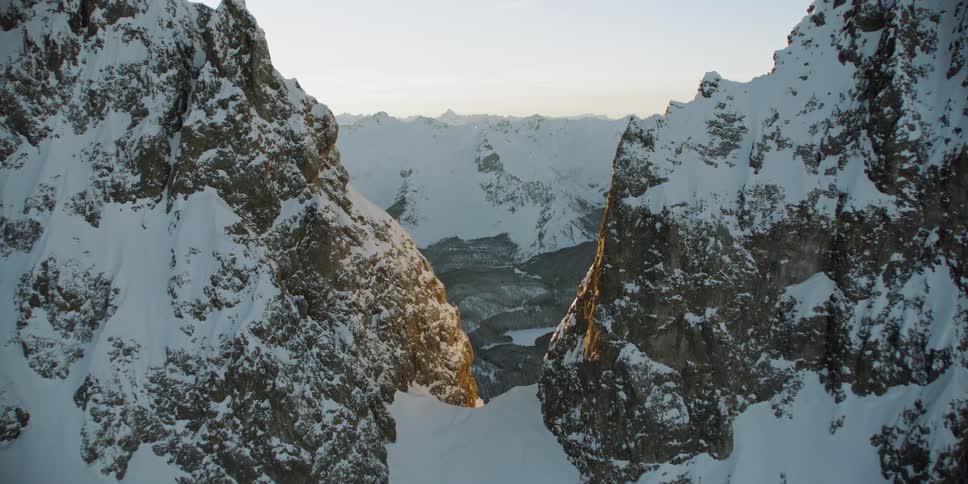 Snow covered ridges and slopes at sunrise