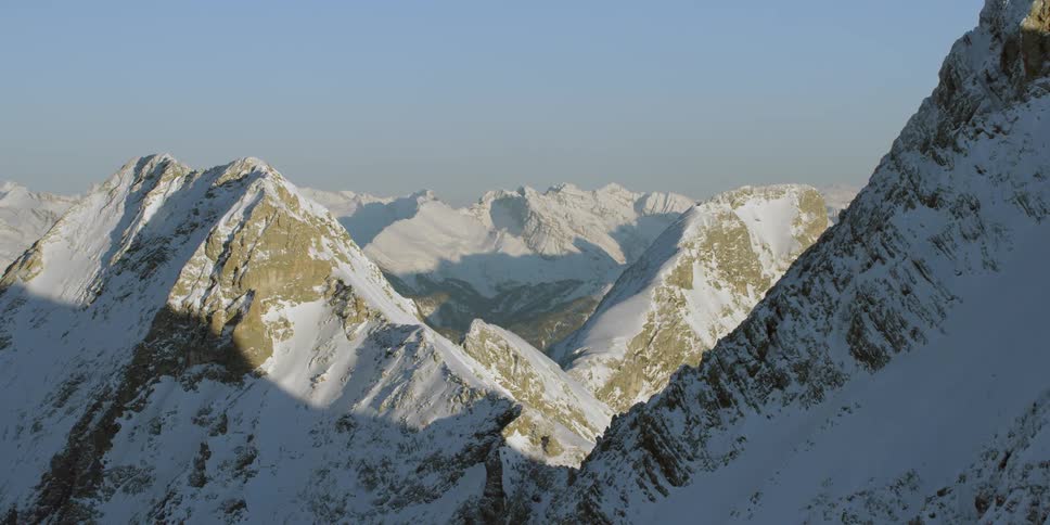 Snow covered mountains under a blue sky