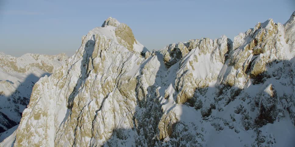Snow covered mountains under a blue sky