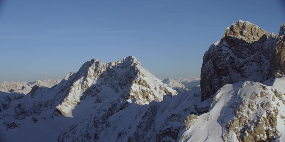 Snow covered rocky peaks on a sunny day