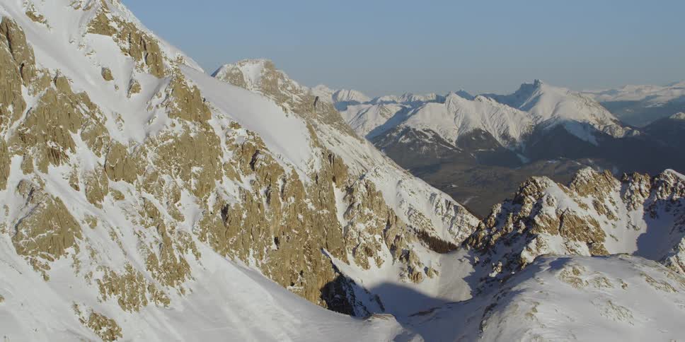 Snow covers rocky mountain peaks
