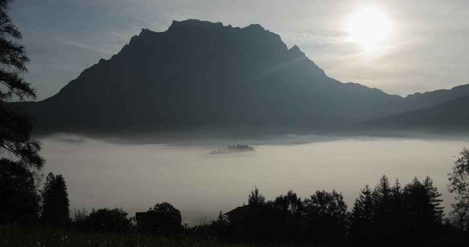 Fog floats at the base of a mountain