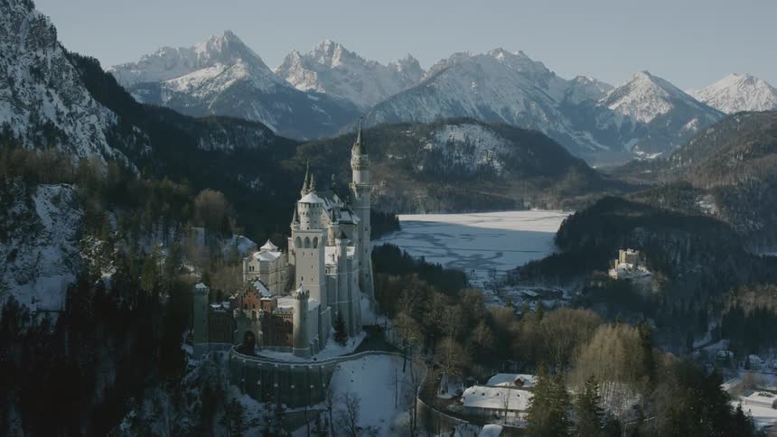 A castle sits in snowy mountains