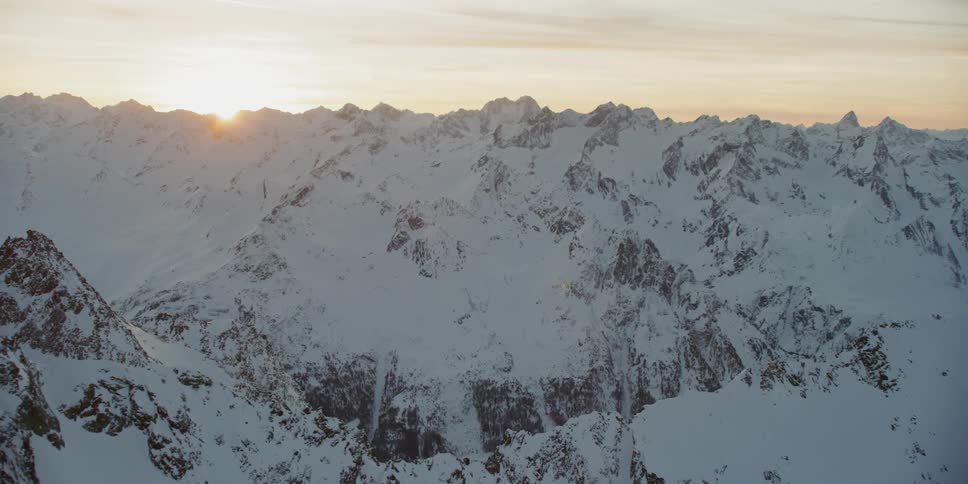 Snow covered ridges and peaks at sunset