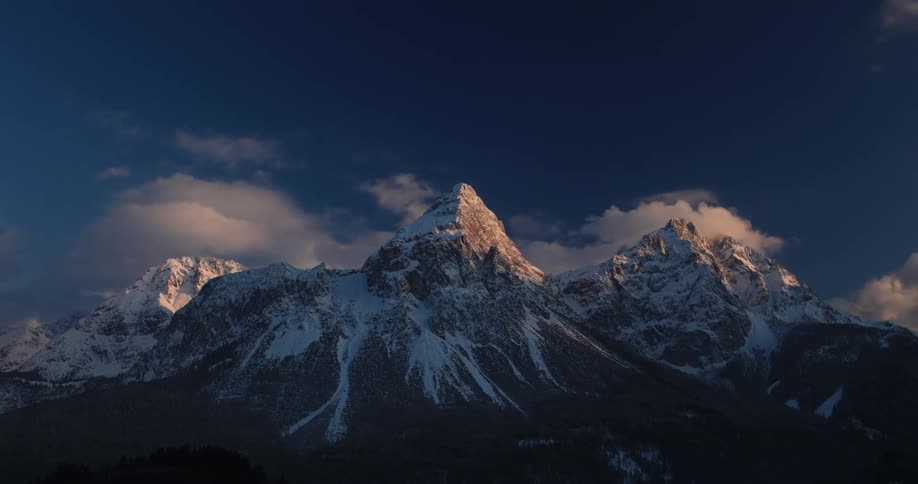 Clouds pass above the mountains