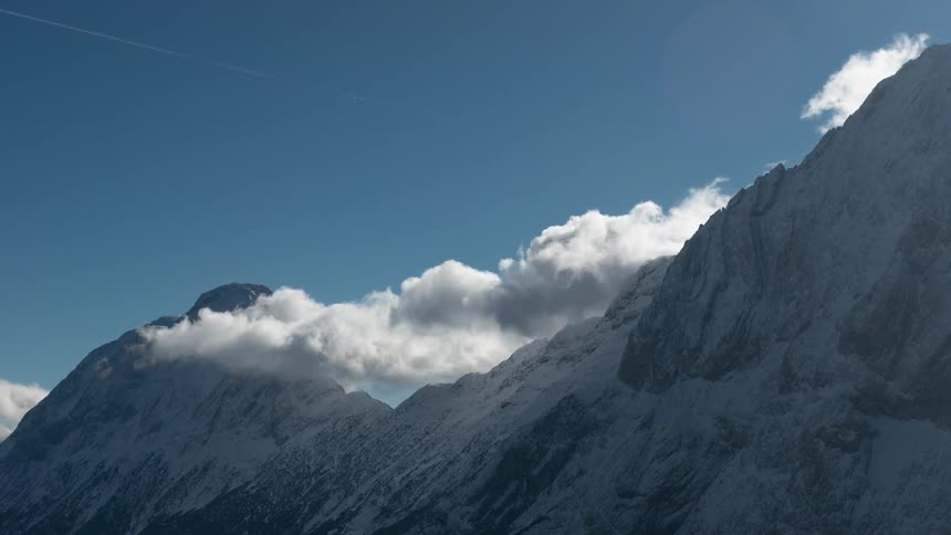 Clouds float over a mountain ridge