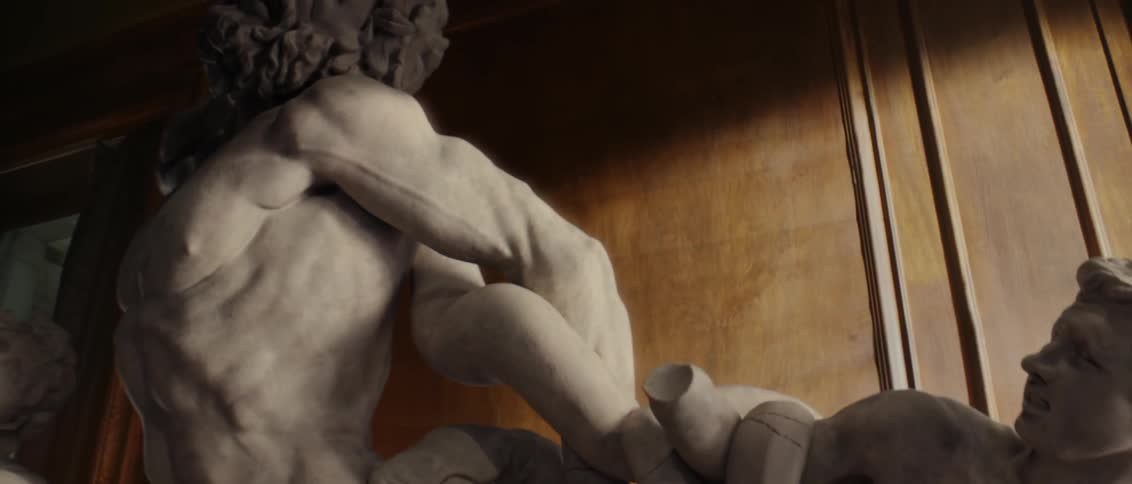 Statue sits next to a wall