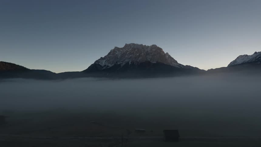 Fog floats at the base of a mountain