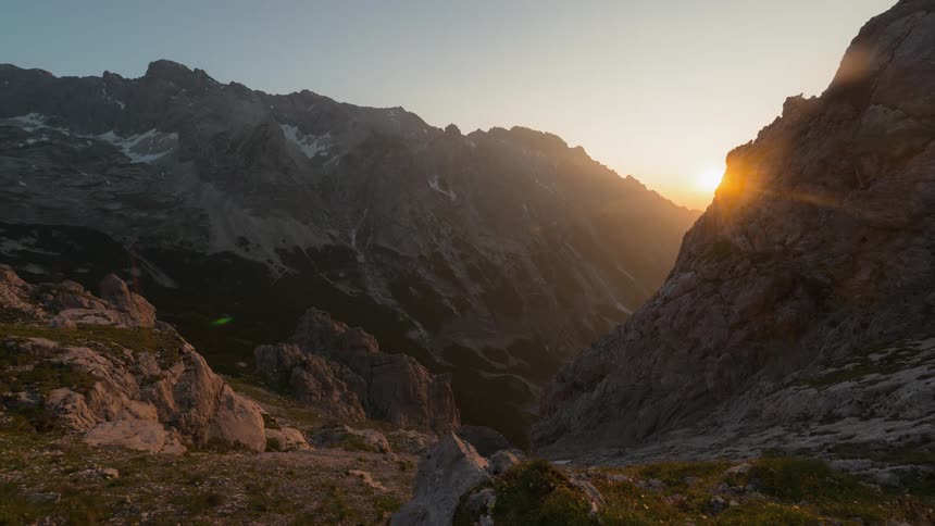 The sun rises over mountains