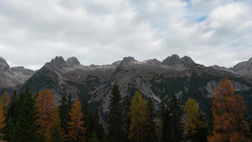 Clouds roll over trees and mountains
