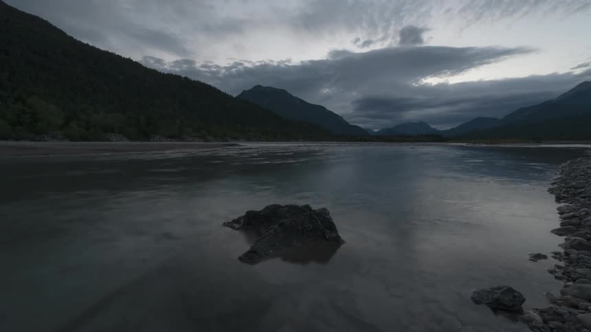 Clouds float over a mountain lake