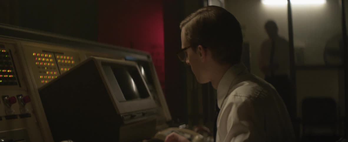 Man wearing glasses looks in an old monitor