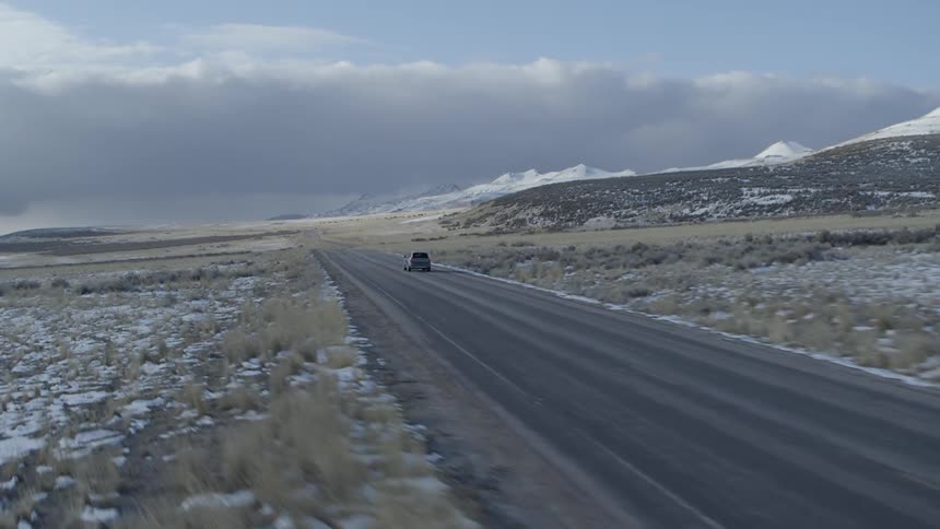 Driving down a road near the mountains