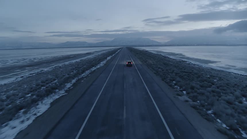 A car drives on a rural road