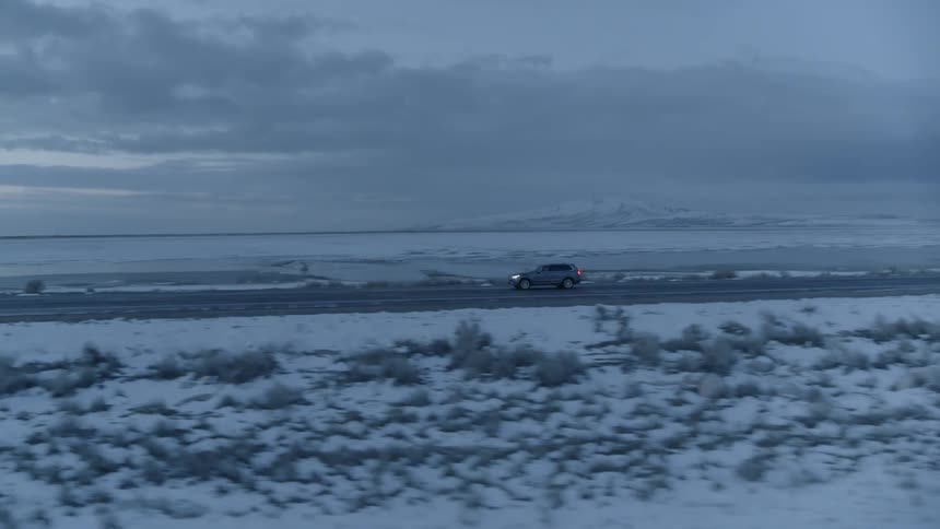 A truck drives down a coastal road