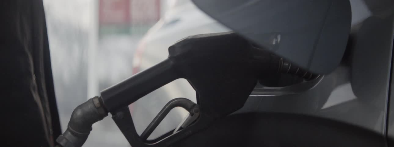 A man puts gas in a car