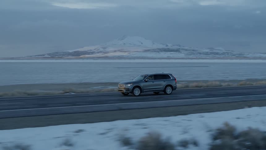 Car travels on a rural lakeside road