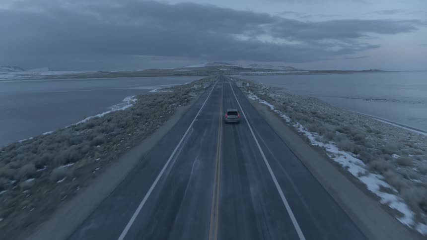 A truck drives on the coastal road