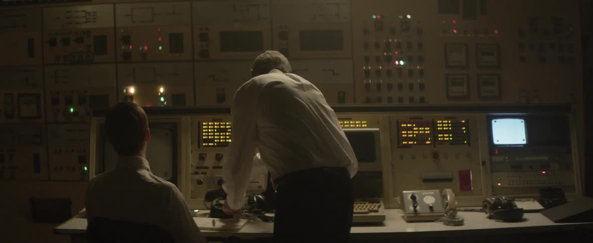 Two men talk in the server room