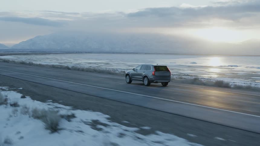 A truck drives on the coastal road
