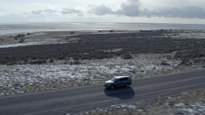 A car drives on a rural road