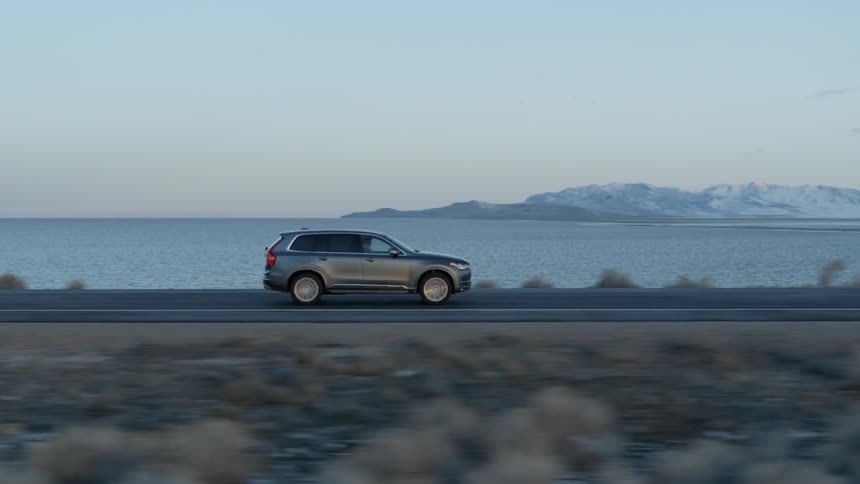 A car drives down the coastal road