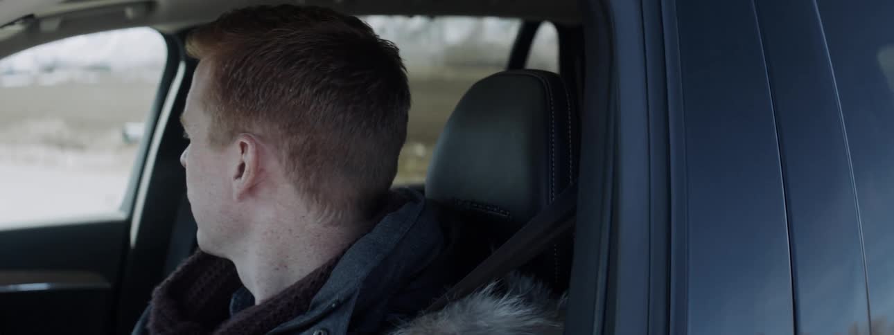 A man is driving a vehicle on a sunny day