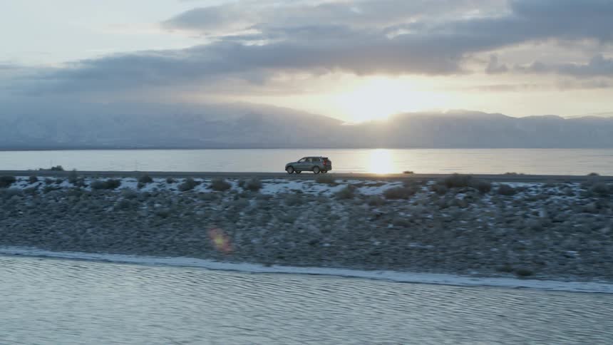 A truck drives down the coastal road