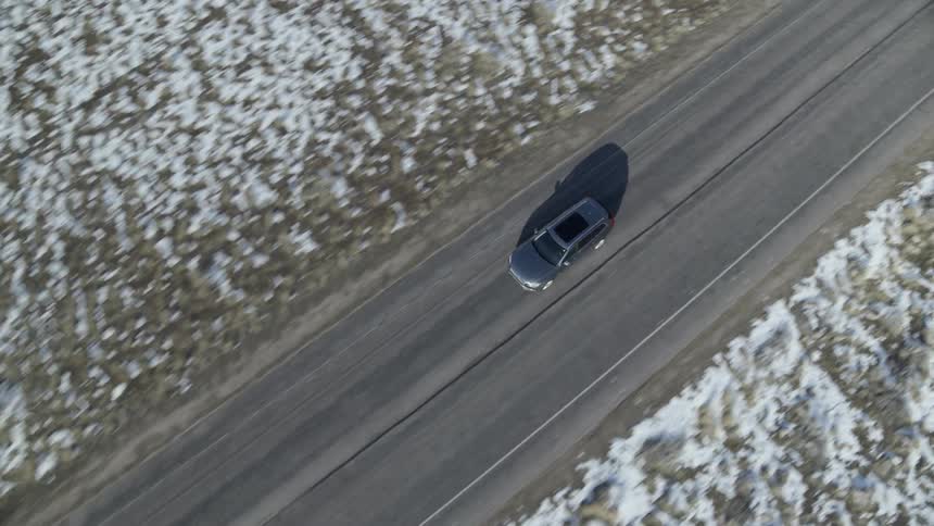 A car drives on the rural road