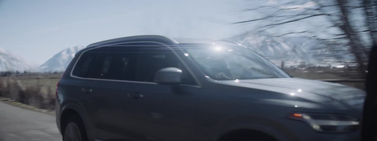 Car travels along mountain valley road