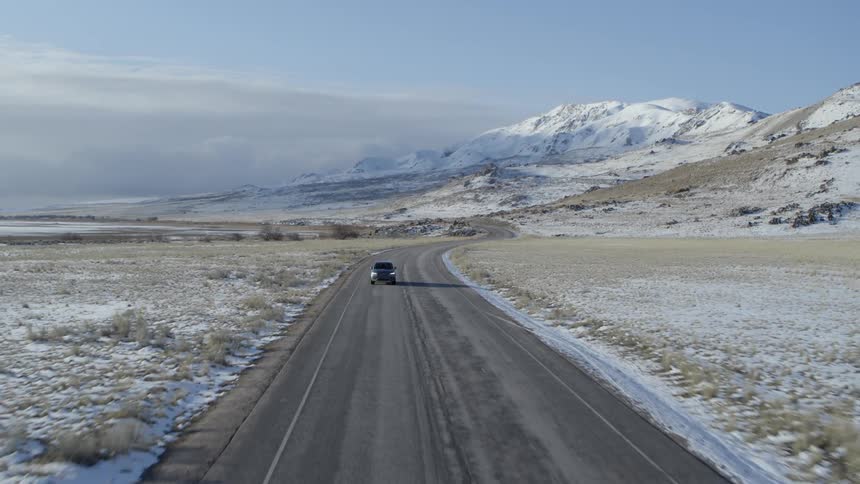A truck drives down the rural road