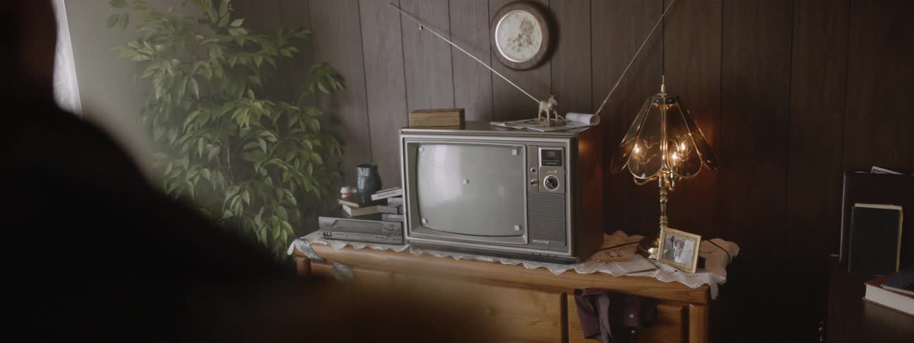 An old television sits on a stand