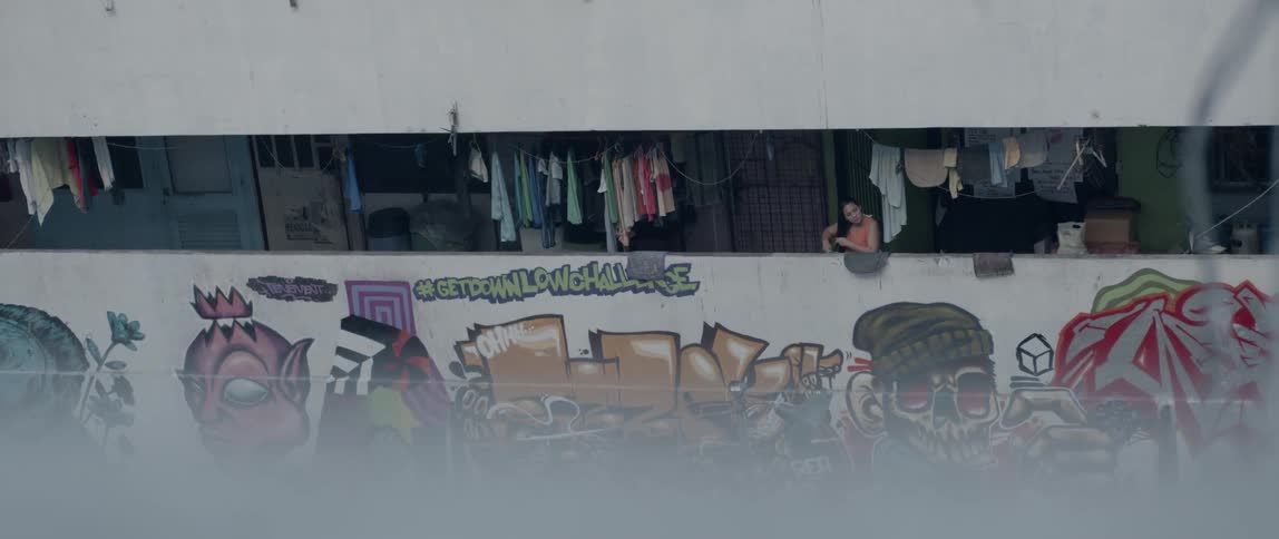 The terrace of the building has many pieces of clothing hanging