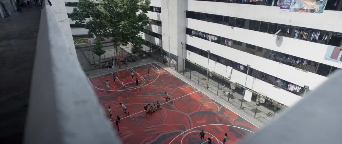 A basketball court sits in an apartment courtyard