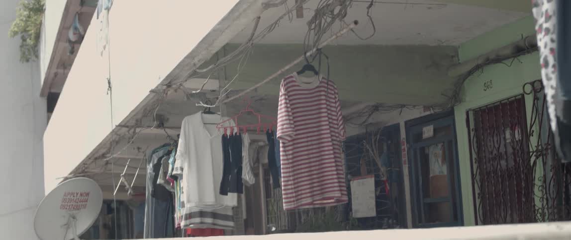 Clothes hang to dry outside of apartments