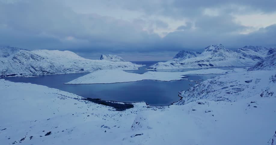 Snowy mountains surround a lake