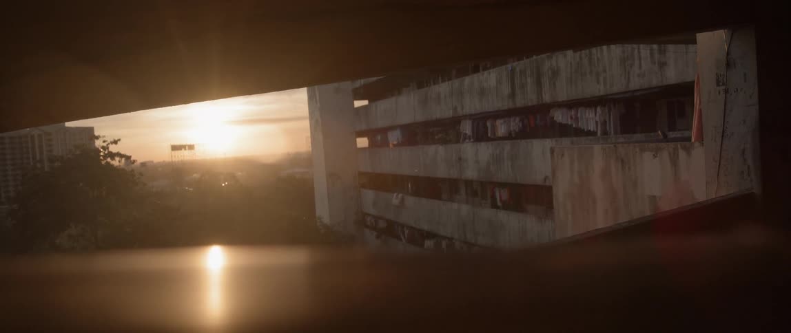 Sun rises over a city and parking ramp