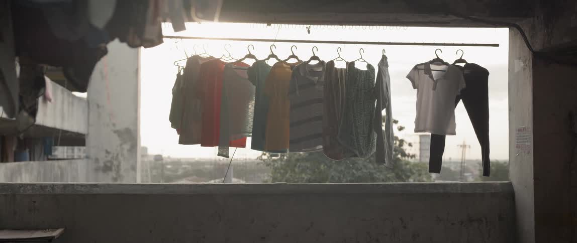 Clothes waver in the breeze as they hang on hangers